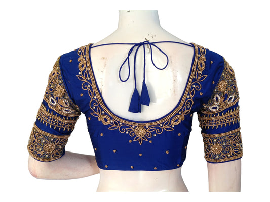 "Navy Elegance: Handmade Aari Work Bridal Silk Saree Blouse, featuring exquisite craftsmanship and luxurious design for a timeless bridal look."